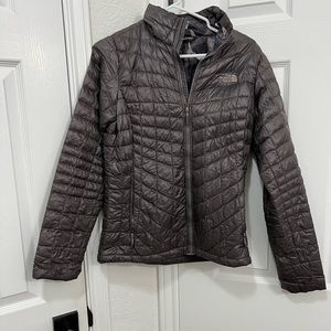 Small North Face jacket. Color is purple with a hint of grey.